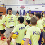 San Benito Greyhounds Basketball Coach Eddie Abrego is seen with Hoops Camp participants on Monday at the high school gymnasium. The camp is expected to be held throughout the week, ending Thursday.